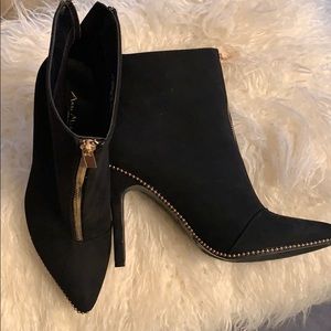 Black ankle boots with gold zippers